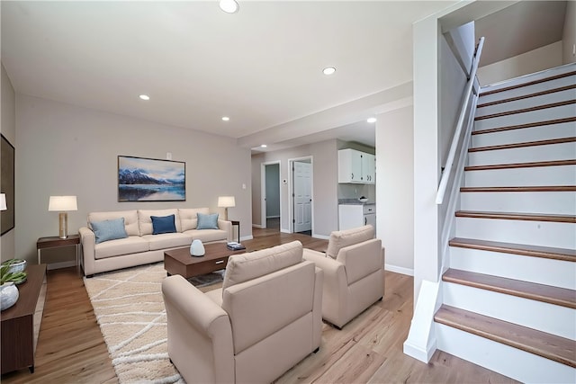 living area featuring stairway, light wood-type flooring, recessed lighting, and baseboards