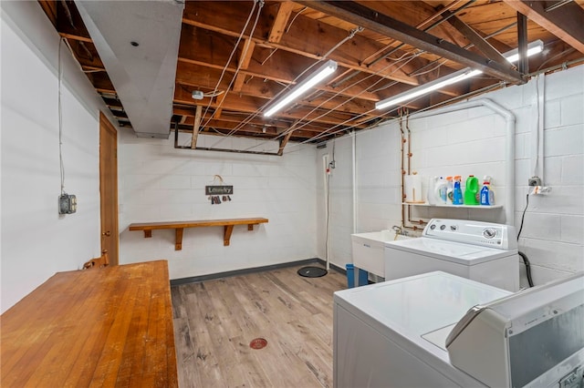 700 Mckinley Ave, City Of Washington, PA 15301 - clothes washing area with a sink, concrete block wall, separate washer and dryer, laundry area, and wood finished floors
