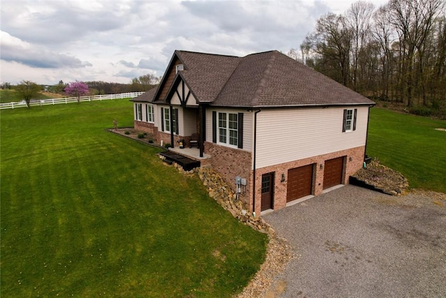 109 Brianna Ln, Oakland Twp, PA 16025 - view of side of property with a lawn, gravel driveway, an attached garage, fence, and brick siding