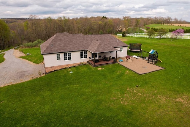 109 Brianna Ln, Oakland Twp, PA 16025 - rear view of property featuring a wooden deck, an outdoor fire pit, a rural view, a yard, and fence