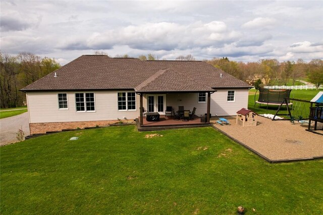 109 Brianna Ln, Oakland Twp, PA 16025 - rear view of property featuring a trampoline, french doors, a wooden deck, and a yard