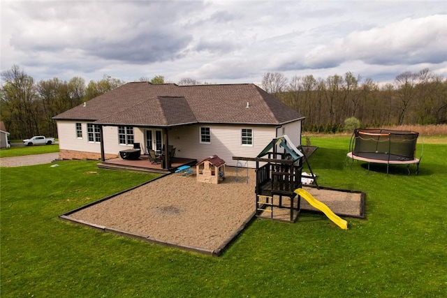 109 Brianna Ln, Oakland Twp, PA 16025 - back of property featuring a lawn, a shingled roof, french doors, and a trampoline