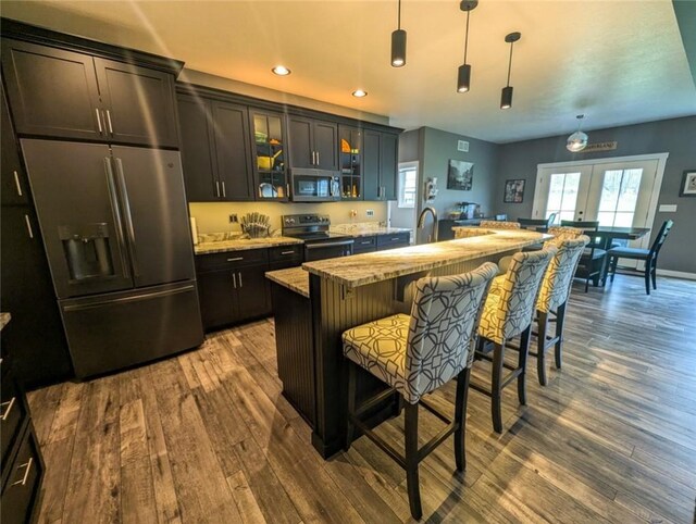109 Brianna Ln, Oakland Twp, PA 16025 - kitchen with glass insert cabinets, stainless steel appliances, dark wood-style flooring, french doors, and a center island with sink