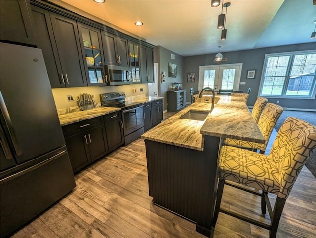 109 Brianna Ln, Oakland Twp, PA 16025 - kitchen with a kitchen breakfast bar, a sink, light wood-style floors, stainless steel appliances, and french doors