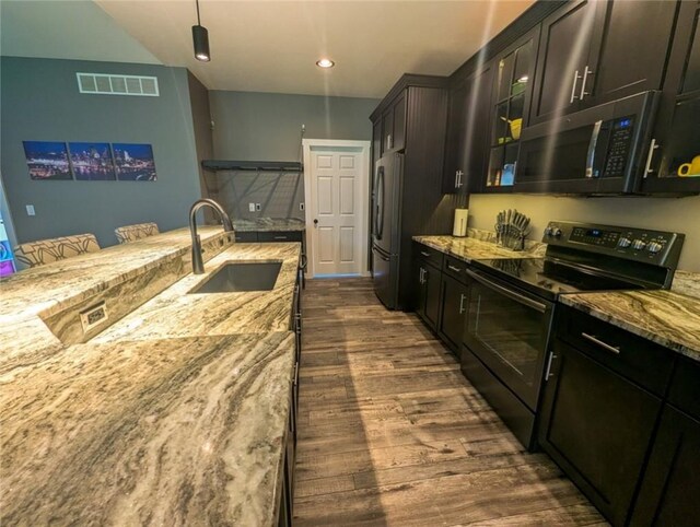 109 Brianna Ln, Oakland Twp, PA 16025 - kitchen with light stone countertops, freestanding refrigerator, a sink, visible vents, and black range with electric cooktop