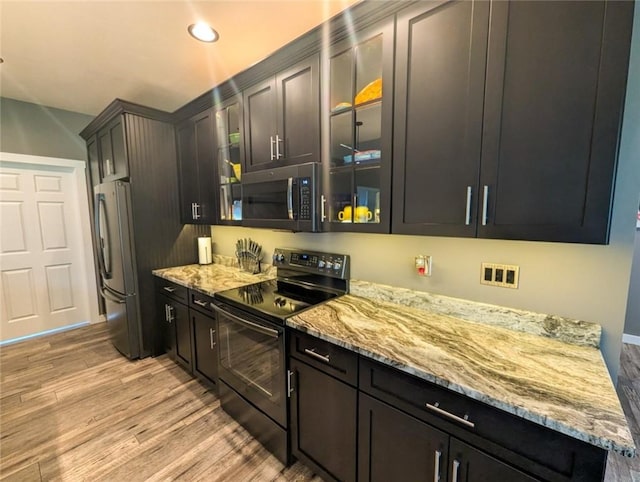 109 Brianna Ln, Oakland Twp, PA 16025 - kitchen featuring glass insert cabinets, black electric range, light wood-style flooring, and freestanding refrigerator