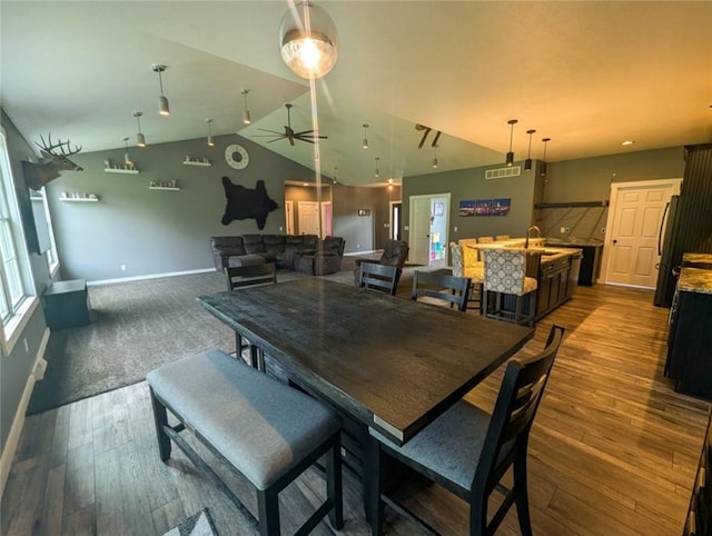 109 Brianna Ln, Oakland Twp, PA 16025 - dining room with dark wood-style flooring, visible vents, vaulted ceiling, and baseboards