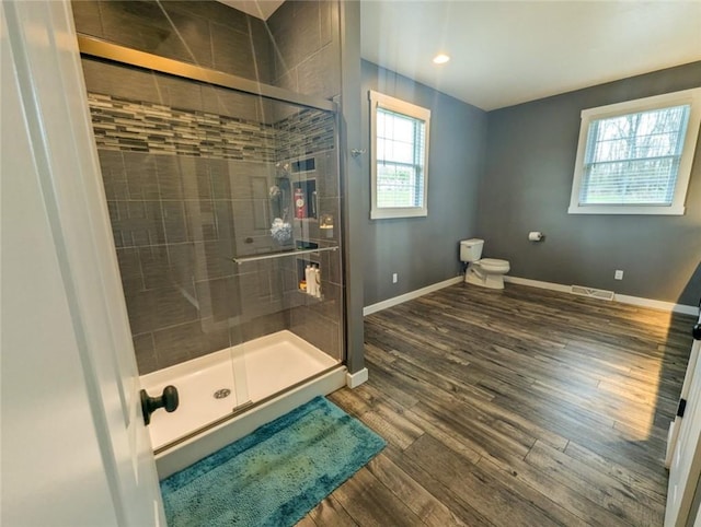 109 Brianna Ln, Oakland Twp, PA 16025 - bathroom with baseboards, wood finished floors, toilet, and a stall shower