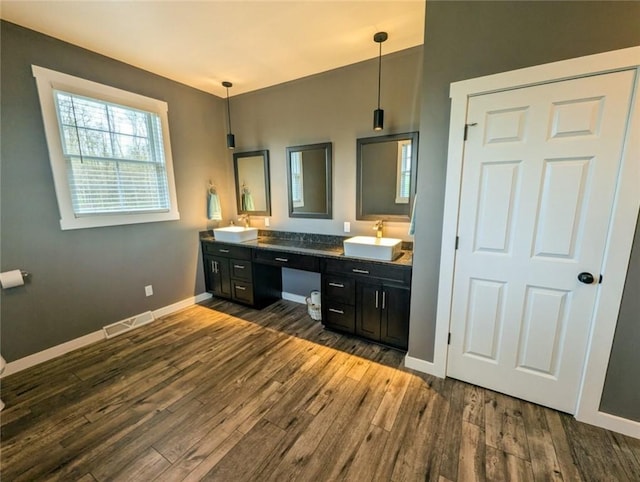 109 Brianna Ln, Oakland Twp, PA 16025 - full bath featuring a sink, double vanity, visible vents, baseboards, and wood finished floors