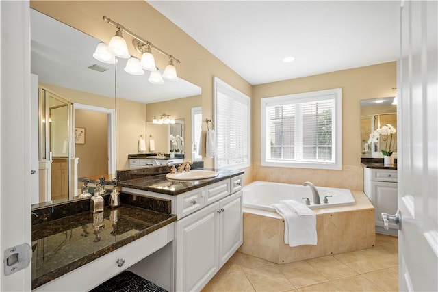 full bathroom with visible vents, a stall shower, a garden tub, vanity, and tile patterned flooring