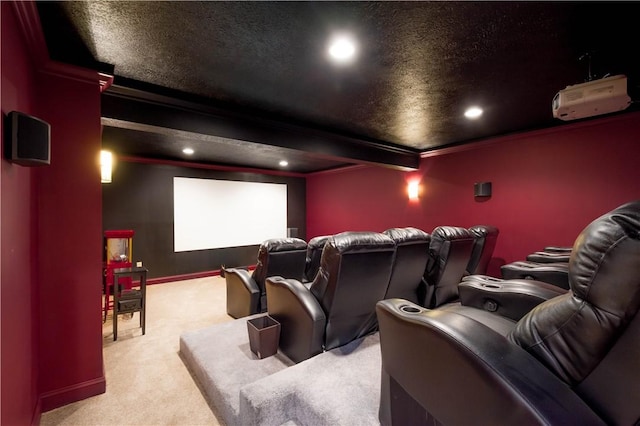 carpeted cinema with baseboards, recessed lighting, beamed ceiling, and crown molding