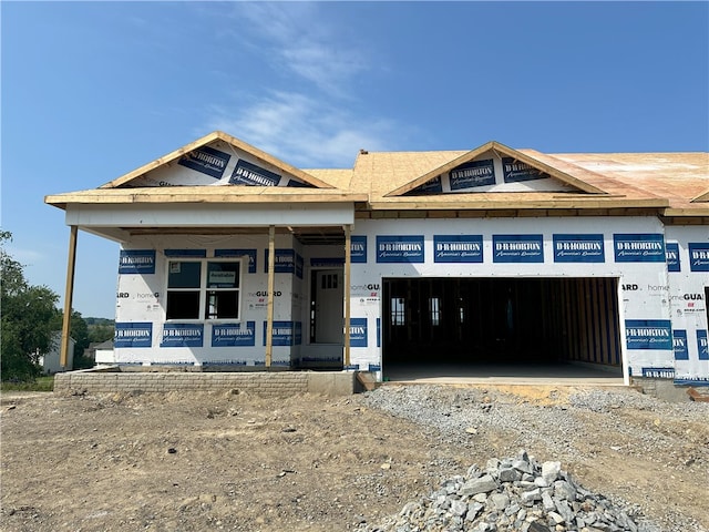 3026 Audrey Dr, Hempfield Twp, PA 15601 - property in mid-construction featuring an attached garage, dirt driveway, and covered porch