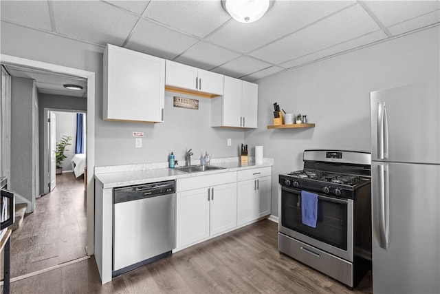 17 Lelia St, Mt Washington, PA 15211 - kitchen featuring stainless steel appliances, a sink, a paneled ceiling, light countertops, and white cabinets
