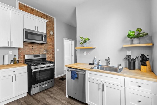 17 Lelia St, Mt Washington, PA 15211 - kitchen with stainless steel appliances, open shelves, butcher block counters, a sink, and white cabinets