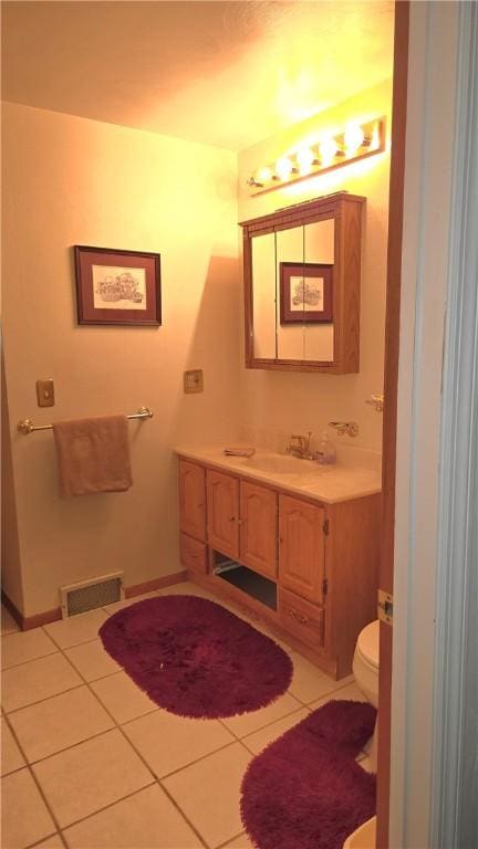 half bathroom with tile patterned floors, visible vents, toilet, and vanity
