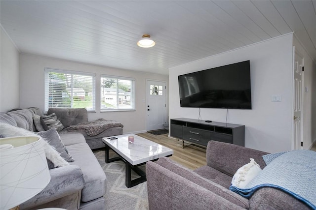living room featuring baseboards, light wood finished floors, and wood ceiling