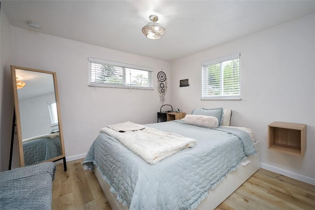 bedroom featuring baseboards and wood finished floors