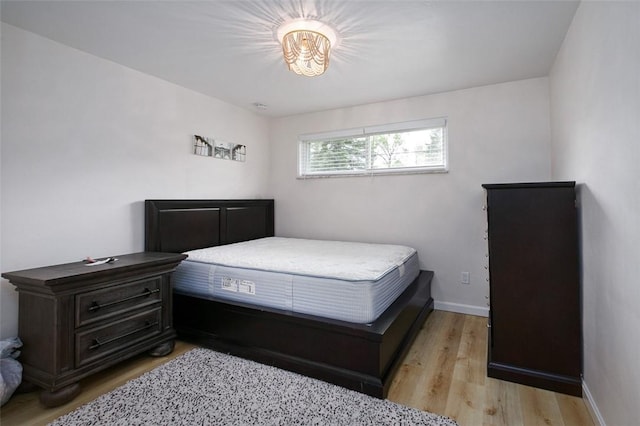 bedroom with baseboards and light wood-type flooring