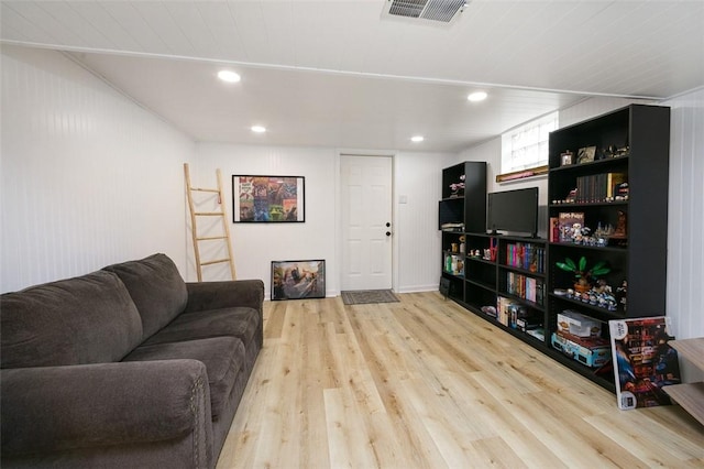 living room with visible vents, wood finished floors, and recessed lighting