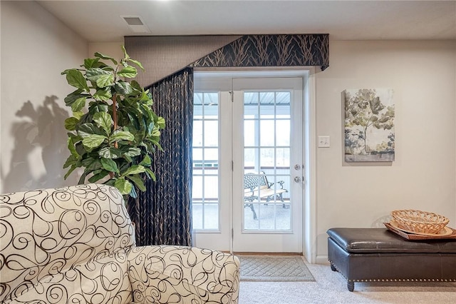 entryway featuring carpet flooring, visible vents, and baseboards