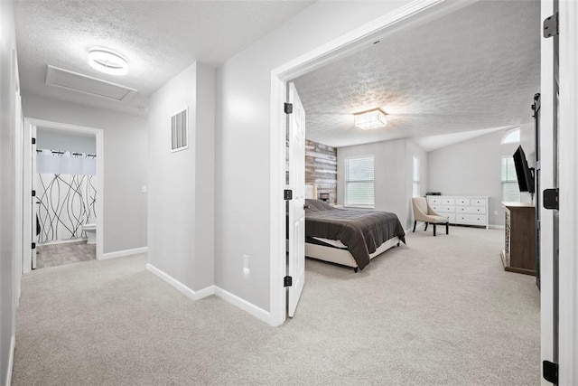 carpeted bedroom featuring baseboards, visible vents, attic access, and a textured ceiling