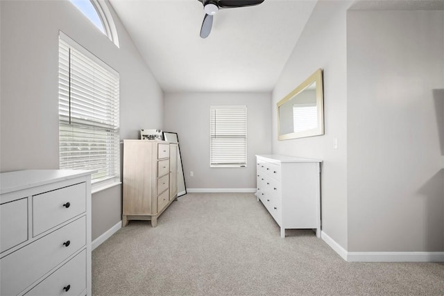unfurnished bedroom featuring multiple windows, light carpet, and baseboards