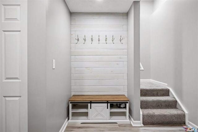 mudroom with baseboards and wood finished floors