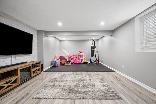 exercise room featuring wood finished floors and baseboards
