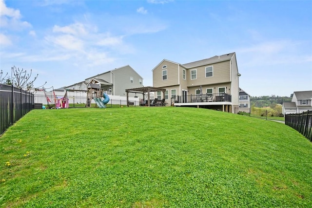 back of property featuring a residential view, a yard, a playground, and a fenced backyard