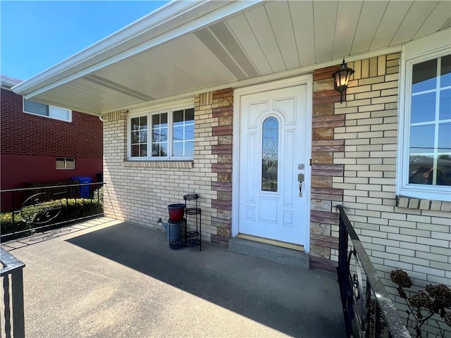 doorway to property featuring brick siding