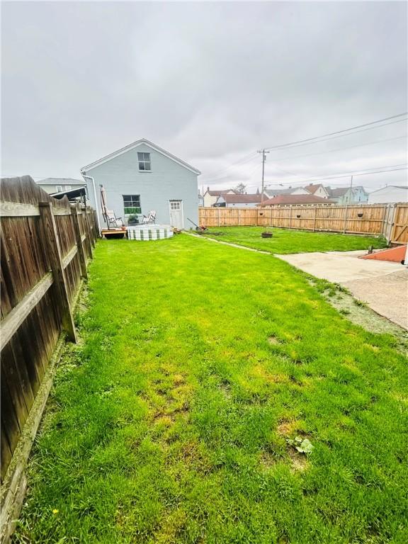 view of yard with a patio and a fenced backyard