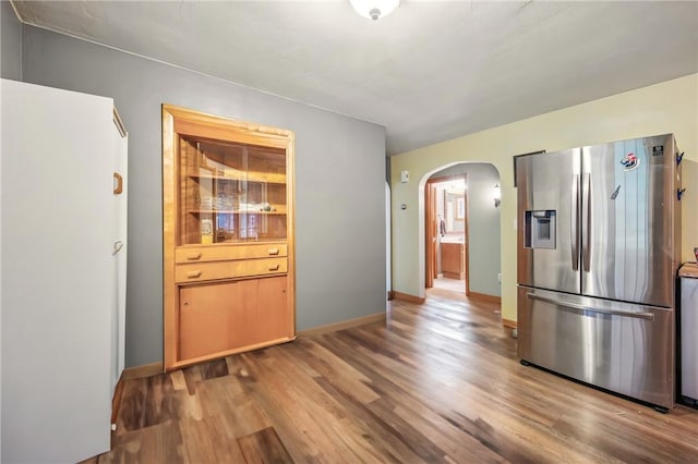 940 Fredonia Rd, Perry Twp Mer, PA 16130 - kitchen featuring baseboards, arched walkways, wood finished floors, and stainless steel fridge with ice dispenser