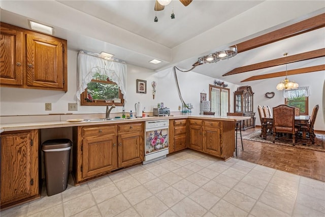kitchen featuring a sink, brown cabinetry, a peninsula, light countertops, and dishwasher