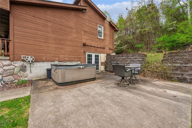 view of patio / terrace featuring french doors and a hot tub