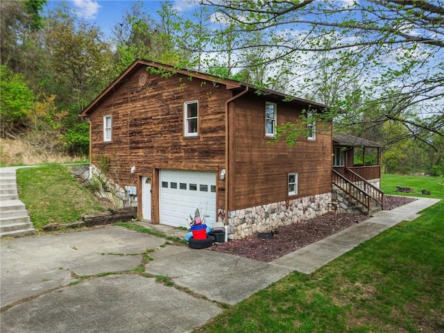 view of property exterior featuring stairs, a yard, a garage, and driveway