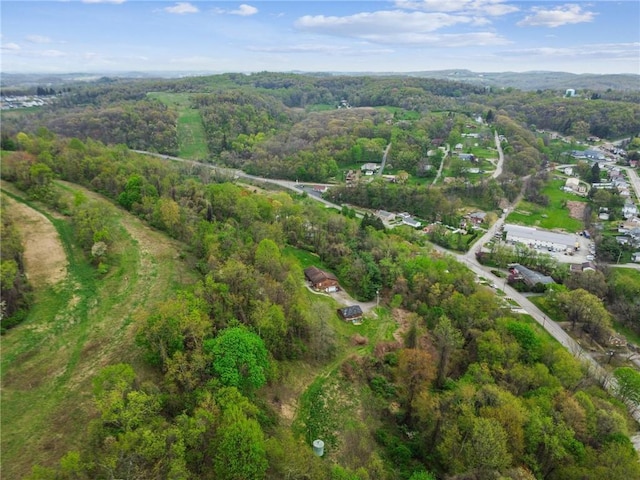 drone / aerial view featuring a wooded view
