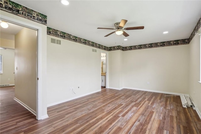 unfurnished room featuring visible vents, baseboards, ceiling fan, and wood finished floors
