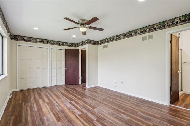 unfurnished bedroom featuring baseboards, recessed lighting, wood finished floors, and visible vents