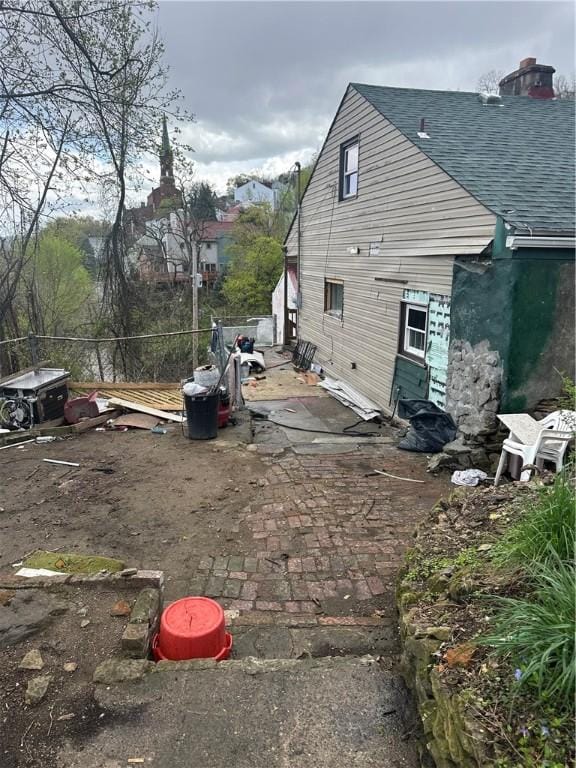 10 Welsh Way S, Side, PA 15203 - view of side of home featuring a chimney, a patio area, and roof with shingles