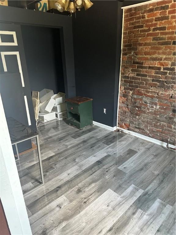 10 Welsh Way S, Side, PA 15203 - unfurnished dining area featuring wood finished floors, a ceiling fan, and brick wall