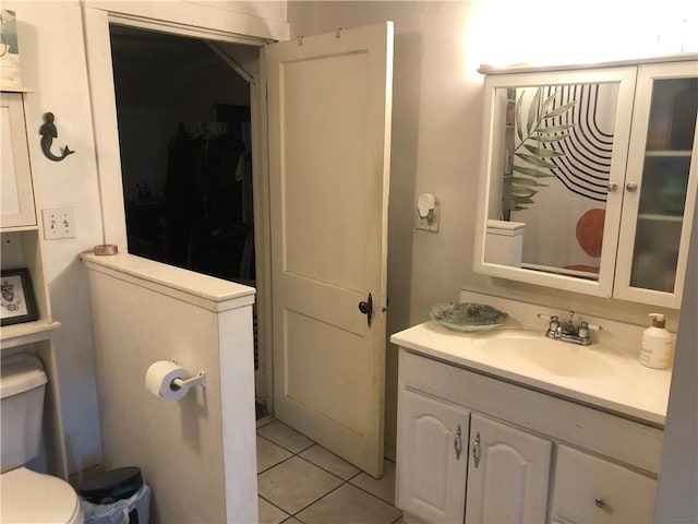 bathroom featuring vanity, toilet, and tile patterned flooring