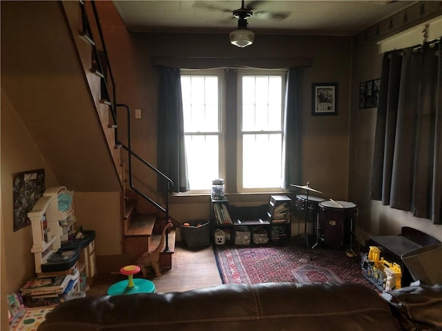living area with stairway and wood finished floors