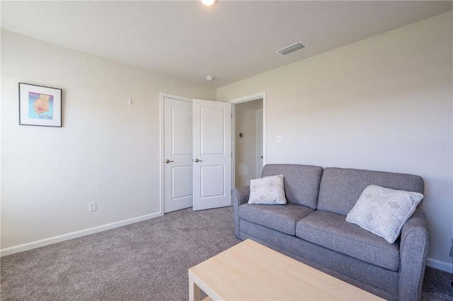 carpeted living room with visible vents and baseboards
