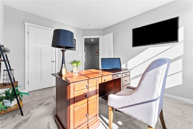 carpeted office featuring baseboards