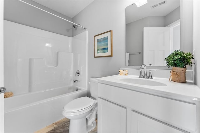 bathroom featuring visible vents, bathing tub / shower combination, toilet, and vanity