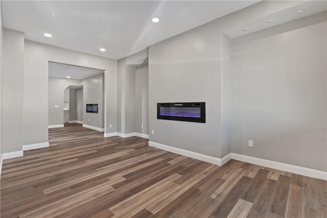 1507 Allegheny Ave, Manchester, PA 15233 - unfurnished living room featuring baseboards, recessed lighting, wood finished floors, and a glass covered fireplace