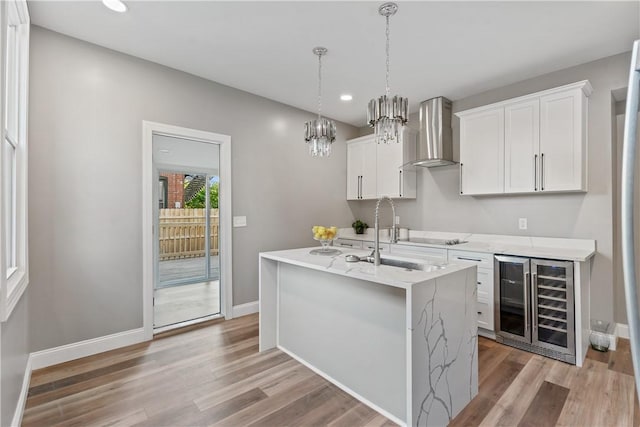 1507 Allegheny Ave, Manchester, PA 15233 - kitchen with wall chimney exhaust hood, light wood finished floors, a sink, and beverage cooler