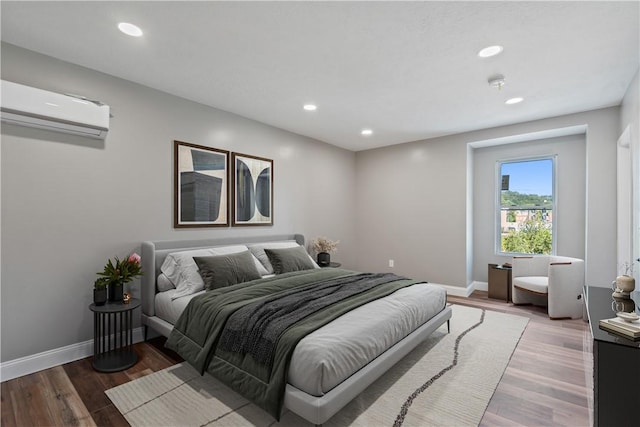 1507 Allegheny Ave, Manchester, PA 15233 - bedroom with wood finished floors, a wall mounted air conditioner, recessed lighting, and baseboards