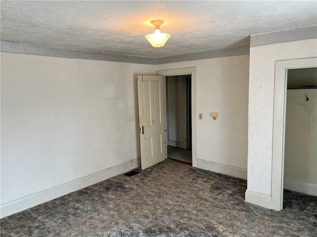 unfurnished bedroom featuring carpet, visible vents, baseboards, and a textured ceiling