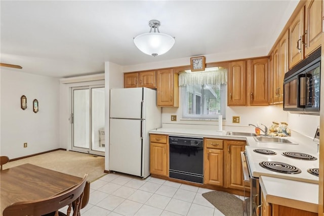 kitchen with black appliances, brown cabinetry, and light countertops